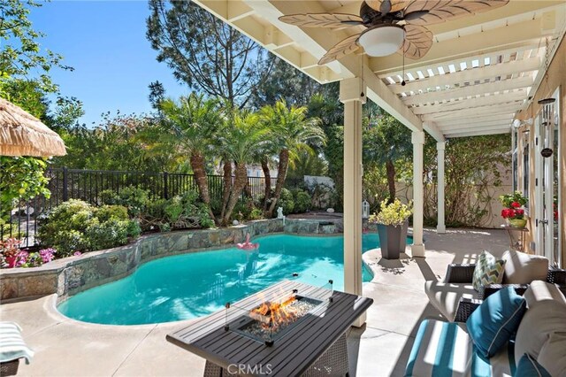 view of swimming pool with a ceiling fan, a fire pit, a fenced backyard, a fenced in pool, and a patio