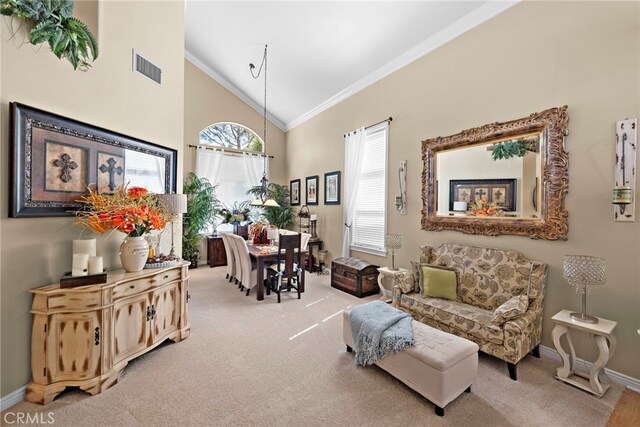 sitting room with ornamental molding, visible vents, and carpet flooring