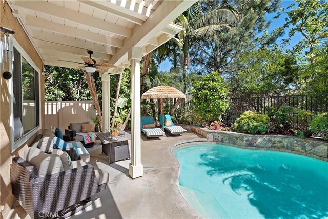 view of pool with a fenced in pool, a fenced backyard, a patio area, ceiling fan, and an outdoor living space