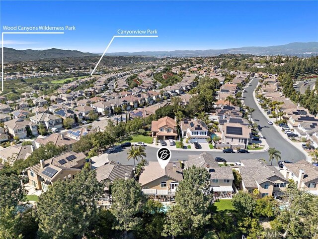 drone / aerial view with a residential view and a mountain view