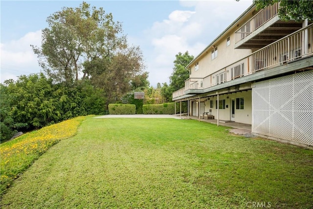 view of yard featuring a deck and a patio