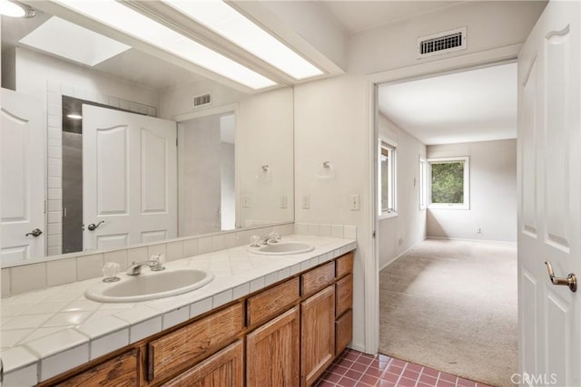 full bath featuring visible vents, a sink, and double vanity