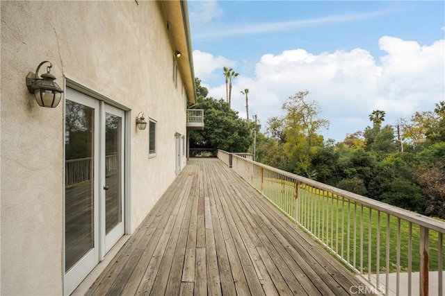 wooden terrace featuring a yard