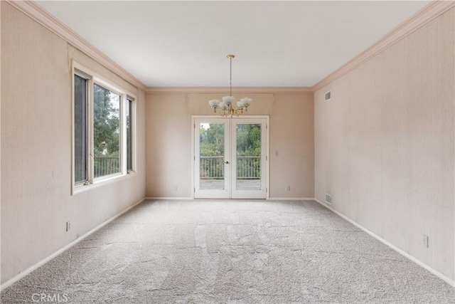 unfurnished room with ornamental molding, carpet flooring, a chandelier, and visible vents