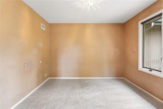 unfurnished room featuring visible vents and carpet