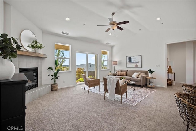 living room featuring visible vents, carpet floors, a fireplace, ceiling fan, and vaulted ceiling
