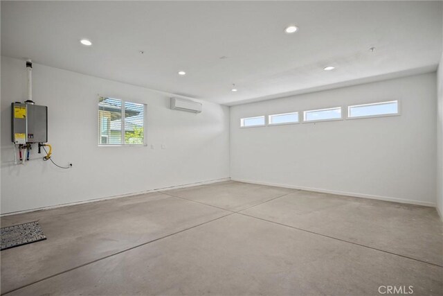 2991 Longwood Dr, Chico, CA 95928 - garage featuring water heater, baseboards, a wall mounted AC, and recessed lighting