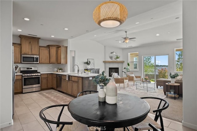 kitchen featuring recessed lighting, a peninsula, backsplash, and stainless steel appliances