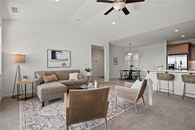 living area featuring a ceiling fan, light carpet, vaulted ceiling, and recessed lighting