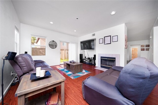 29444 Siderite Cir, Menifee, CA 92584 - living area featuring visible vents, a tiled fireplace, and wood finished floors