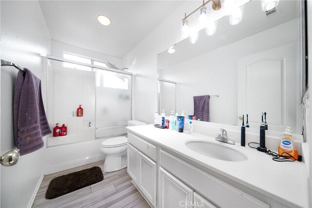 29444 Siderite Cir, Menifee, CA 92584 - full bath with vanity, visible vents, wood finished floors, toilet, and combined bath / shower with glass door