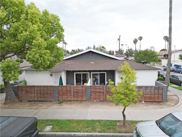 3100 Garnet Ln, Fullerton, CA 92831 - ranch-style home with a fenced front yard, stucco siding, and roof with shingles