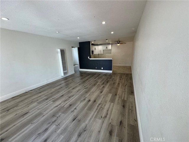3100 Garnet Ln, Fullerton, CA 92831 - unfurnished living room with a ceiling fan, recessed lighting, a textured ceiling, baseboards, and wood finished floors