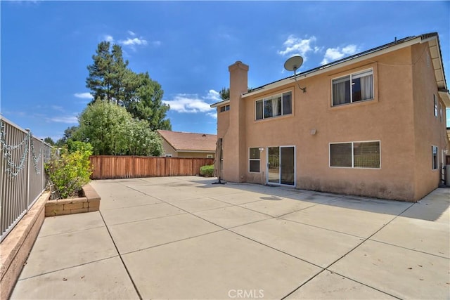 32000 Corte Sagunto, Temecula, CA 92592 - back of house featuring a fenced backyard, a chimney, a patio area, and stucco siding