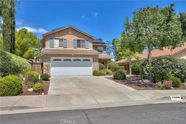 32000 Corte Sagunto, Temecula, CA 92592 - traditional-style house with driveway, solar panels, an attached garage, stone siding, and stucco siding