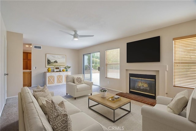 32000 Corte Sagunto, Temecula, CA 92592 - carpeted living room featuring a glass covered fireplace, baseboards, a ceiling fan, and visible vents