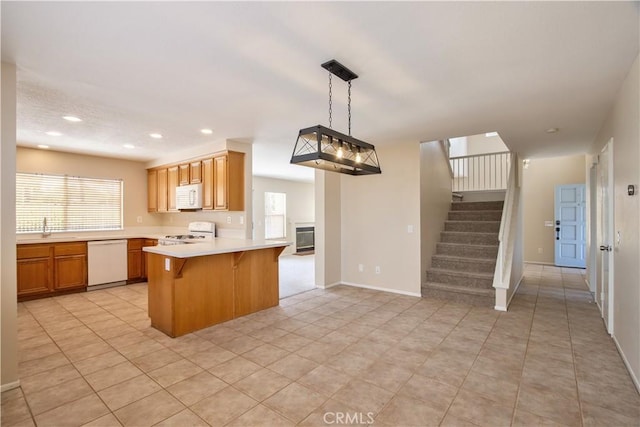 32000 Corte Sagunto, Temecula, CA 92592 - kitchen featuring a breakfast bar, white appliances, light countertops, a peninsula, and recessed lighting