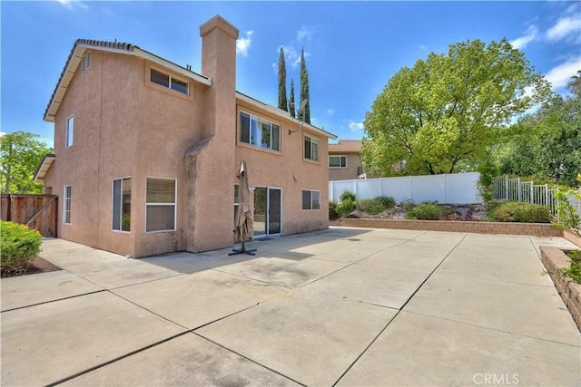 32000 Corte Sagunto, Temecula, CA 92592 - rear view of property with a patio, a fenced backyard, stucco siding, and a chimney