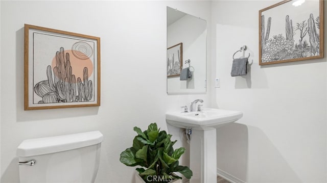 half bathroom with toilet and a sink