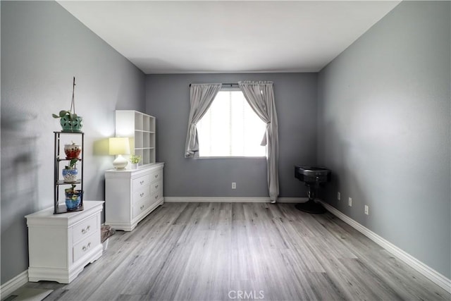 unfurnished bedroom featuring baseboards and light wood finished floors