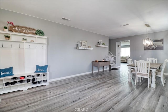 dining area with visible vents, baseboards, and wood finished floors