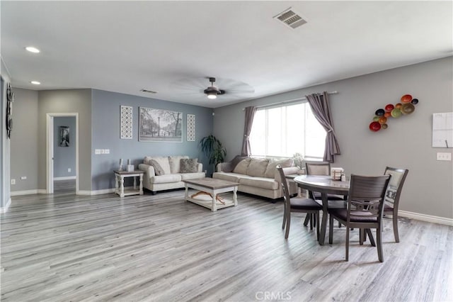 living room with a ceiling fan, baseboards, visible vents, and light wood-style flooring