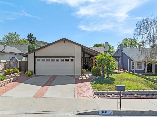 single story home featuring an attached garage, a front lawn, and driveway