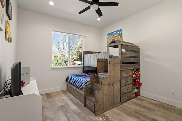 bedroom with recessed lighting, wood finished floors, and baseboards
