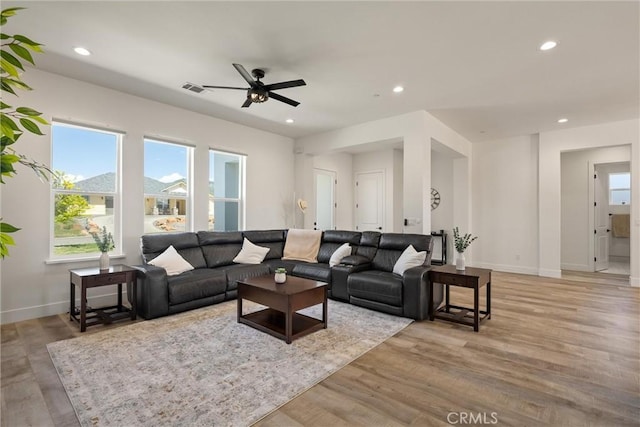 living area featuring visible vents, ceiling fan, baseboards, recessed lighting, and light wood finished floors