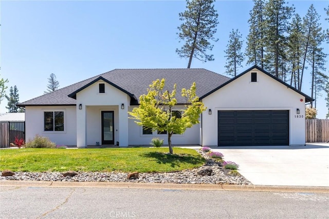 ranch-style home with stucco siding, fence, a garage, a front yard, and concrete driveway