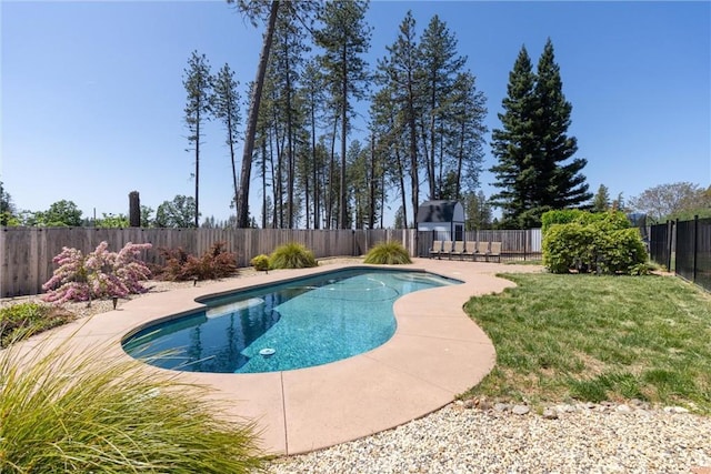 view of swimming pool featuring a fenced backyard, a fenced in pool, and a lawn