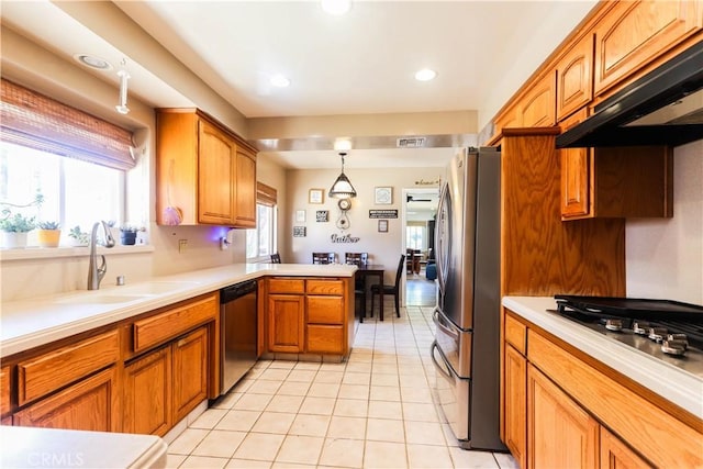 2812 Sunnywood Dr, Fullerton, CA 92835 - kitchen featuring under cabinet range hood, visible vents, a sink, a peninsula, and appliances with stainless steel finishes