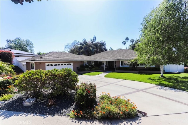 2812 Sunnywood Dr, Fullerton, CA 92835 - single story home featuring concrete driveway, an attached garage, stucco siding, and a front yard