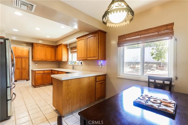 2812 Sunnywood Dr, Fullerton, CA 92835 - kitchen featuring a peninsula, visible vents, brown cabinetry, stainless steel refrigerator with ice dispenser, and light tile patterned floors