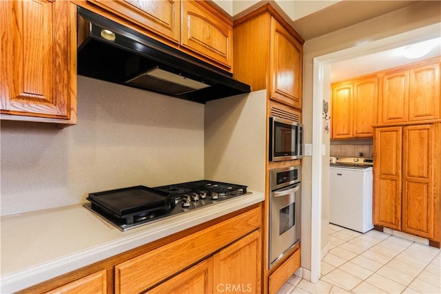 2812 Sunnywood Dr, Fullerton, CA 92835 - kitchen featuring appliances with stainless steel finishes, brown cabinets, light countertops, under cabinet range hood, and light tile patterned floors