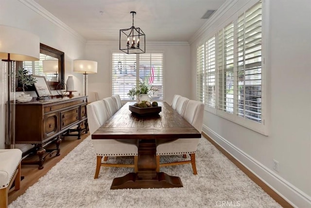 1711 Colina Terrestre, San Clemente, CA 92673 - dining area with wood finished floors, a chandelier, and crown molding