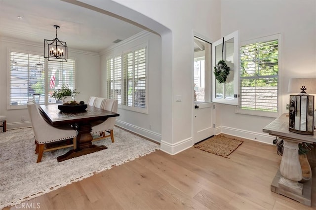 1711 Colina Terrestre, San Clemente, CA 92673 - dining room featuring wood finished floors, a chandelier, crown molding, and arched walkways
