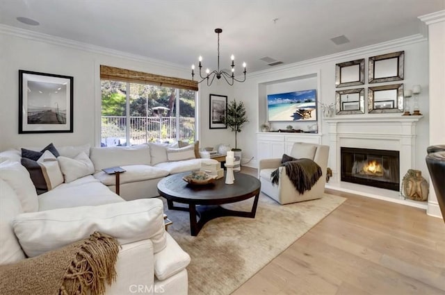 1711 Colina Terrestre, San Clemente, CA 92673 - living area featuring light wood-style floors, a chandelier, ornamental molding, and a glass covered fireplace