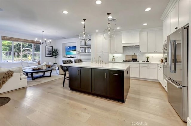 1711 Colina Terrestre, San Clemente, CA 92673 - kitchen with appliances with stainless steel finishes, light countertops, white cabinetry, a chandelier, and crown molding