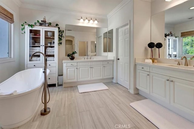 1711 Colina Terrestre, San Clemente, CA 92673 - bathroom with two vanities, a freestanding bath, ornamental molding, and wood finished floors
