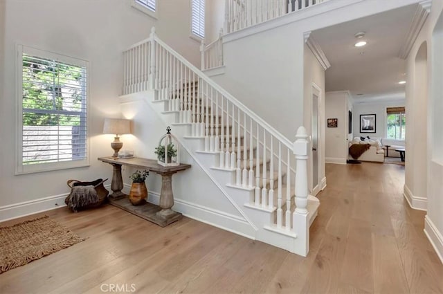 1711 Colina Terrestre, San Clemente, CA 92673 - staircase with wood finished floors, arched walkways, a high ceiling, crown molding, and recessed lighting