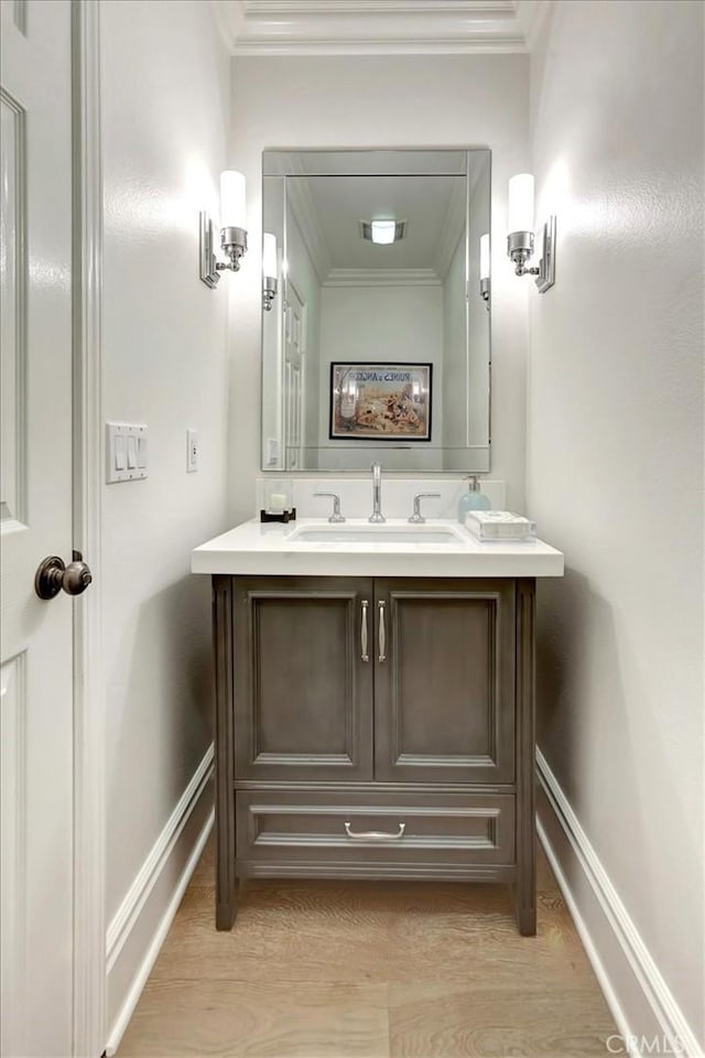1711 Colina Terrestre, San Clemente, CA 92673 - bathroom featuring double vanity, ornamental molding, and wood finished floors