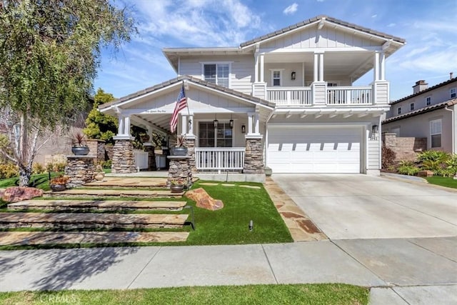 1711 Colina Terrestre, San Clemente, CA 92673 - view of front of home with covered porch, a garage, concrete driveway, stone siding, and board and batten siding