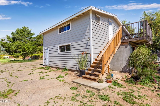 back of house with stairway and a deck