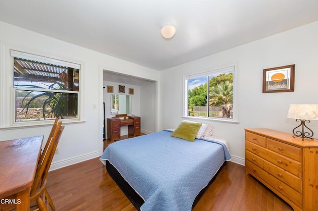 bedroom featuring wood finished floors and baseboards