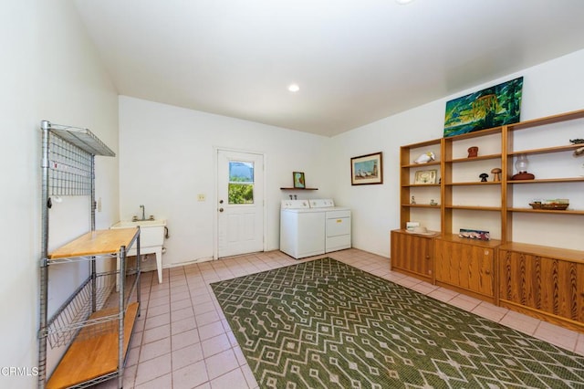 laundry room featuring washing machine and dryer, tile patterned flooring, and laundry area