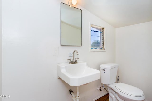half bath with toilet and a sink