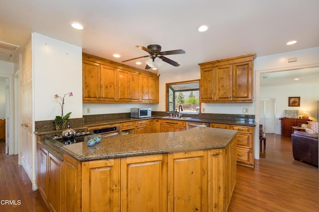 1526 Grand Ave, Fillmore, CA 93015 - kitchen with stainless steel appliances, brown cabinets, ceiling fan, dark stone countertops, and recessed lighting