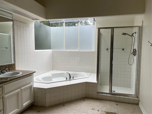 full bathroom with a bath, a shower stall, tile patterned floors, and vanity