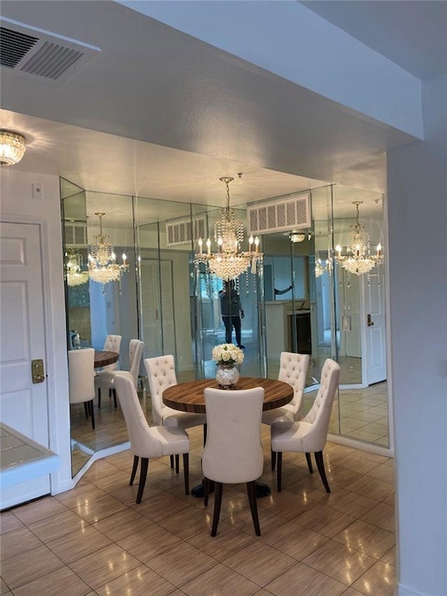tiled dining room with a notable chandelier and visible vents